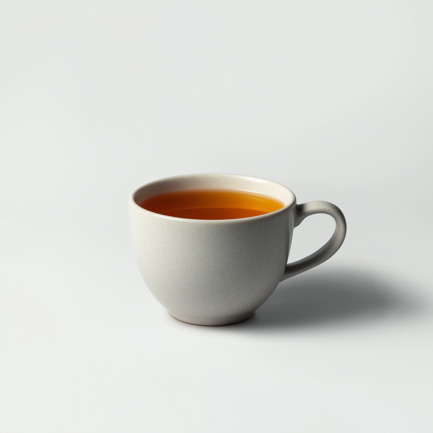 A single ceramic cup of herbal tea on a pale surface